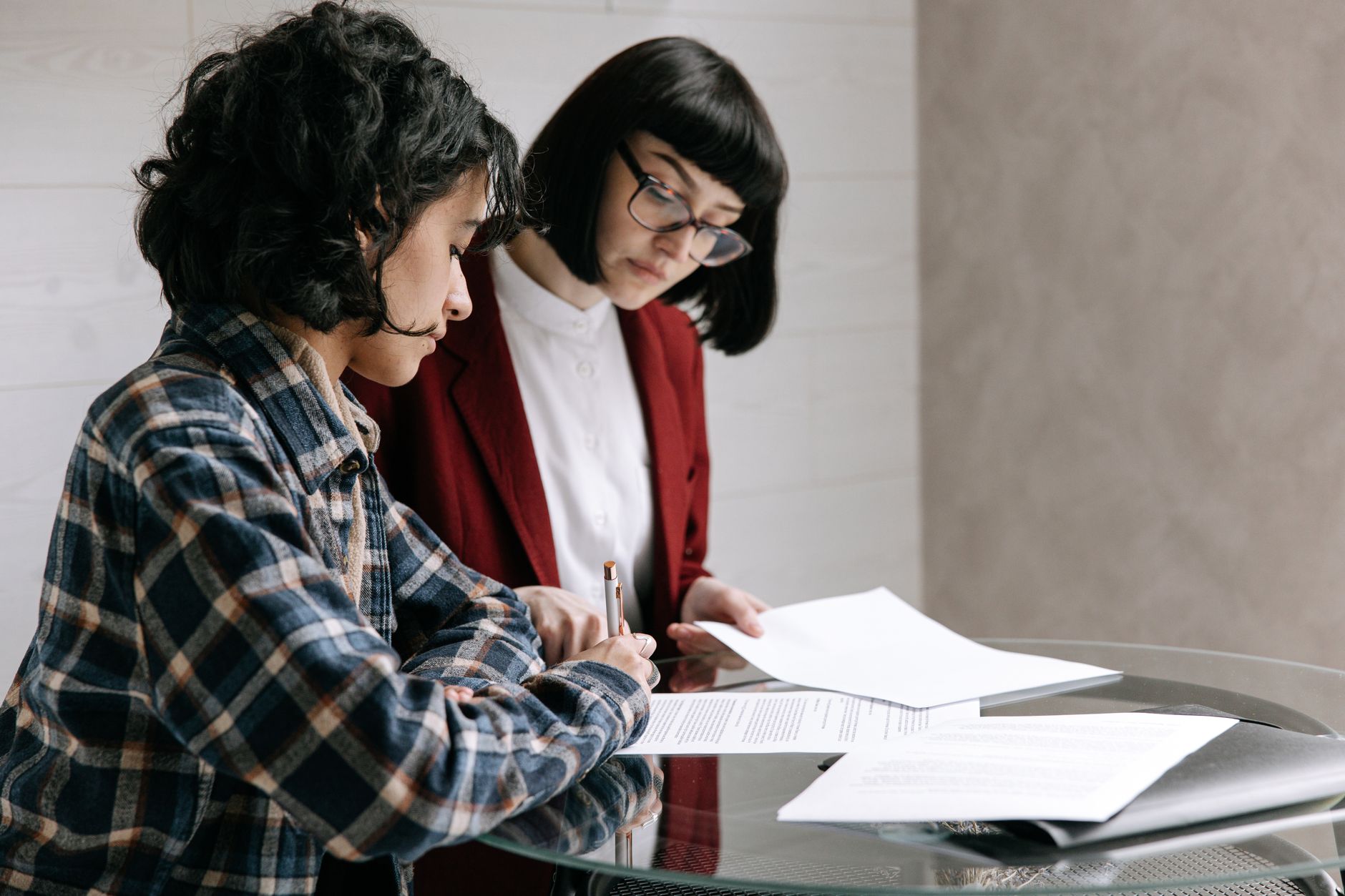 Deux personnes comparant des documents autour d'une table